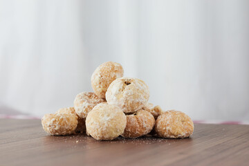 A pile of assorted chips on a wooden table - Stuffed Cavaca.