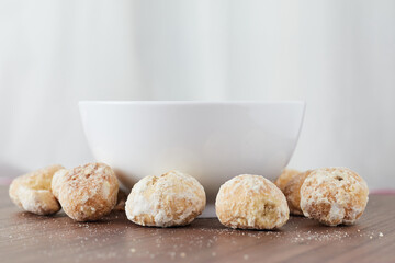 A handful of assorted chips around a white bowl on a wooden table - Stuffed Cavaca.