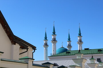 The muslim mosque is visible against the blue clear sky