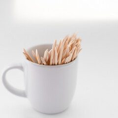 Wooden manicure sticks on white isolated background. Beauty and aesthetics