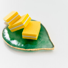 Buff yellow, for manicure on a leaf on a white background