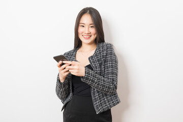 Portrait of Asian woman using mobile phone application and pointing finger to smartphone isolated over white background.