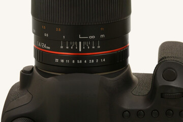 The aperture and focus rings on the barrel of a modern, unbranded DSLR camera lens are shown...