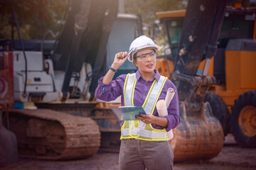 Woman engineers construction worker. Foreman working  with excavator in construction site  background