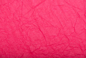 Fototapeta premium Pink crumpled paper texture or background.