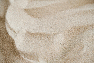 Wavy fine sand texture. Natural background, close-up
