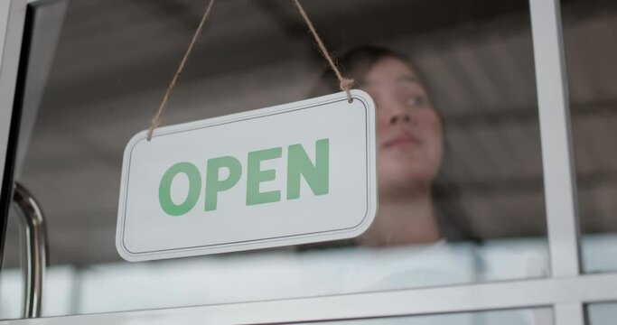 Young woman truning hang signboard with closed word
