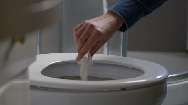 Man Throws Away Cocaine In The Toilet Bowl Then Flushes It - close up