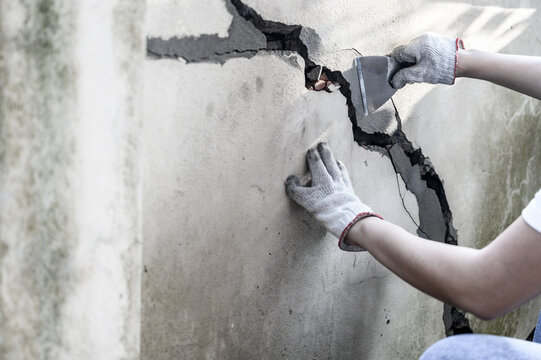 Worker Repair And Fix Cement Fence At Home. DIY Construction And Renovate House.