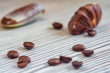 Figures of Belgian chocolate on a light wooden background close-up.