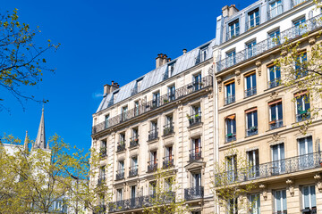 Fototapeta premium Paris, typical building, with the Saint-Ambroise church in background