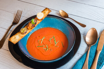 Tomato soup and a toast with quail egg and anchovy