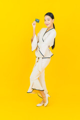 Portrait beautiful young business asian woman with smart mobile phone and credit card