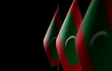 Small national flags of the Maldives on a black background