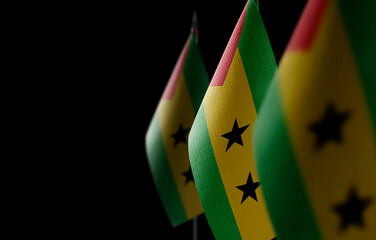 Small national flags of the Sao Tome and Principe on a black background