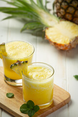pineapple juice on white wooden backgroud