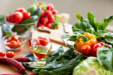 Concept of healthy food, clean eating, vegetarian diet, detox. Fresh delicious vegetables from the market, virgin olive oil are ingredients for light green salad. Close up