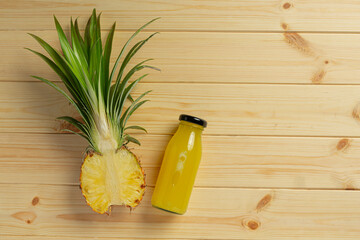 pineapple juice in bottle on wooden backgroud
