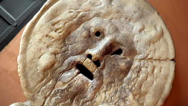 A marble construction in the shape of a mask, called The Mouth of Truth, situated in the portico of the Paleochristian church of Santa Maria in Cosmedin, at the foot of the Aventine hills