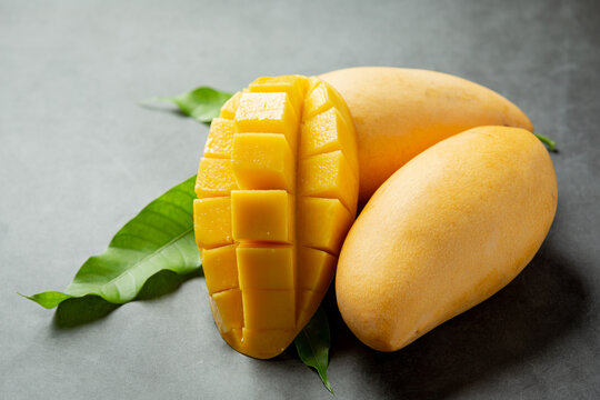 beautiful chopped ripe mango on dark wooden backgroud