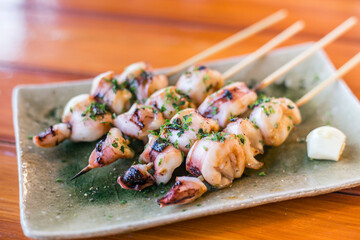 Japanese skwid grill or yakitori serve in izakaya style restourant set on Japanese style