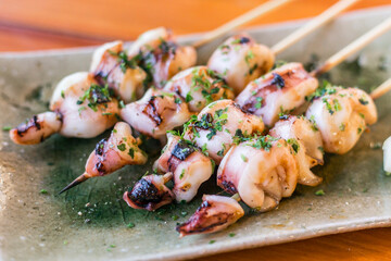 Japanese skwid grill or yakitori serve in izakaya style restourant set on Japanese style