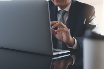 Business man making video conference using zoom online meeting app via laptop computer at office