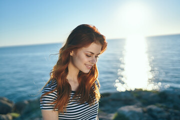 happy woman t-shirt at sunset near the sea in the mountains