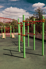 Fototapeta premium green and red horizontal bars on a playground in the summer 
