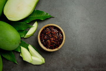 fresh green mango with sweet fish sauce dipping on dark backgroud