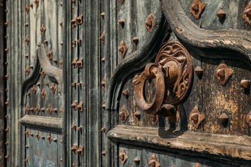 Details of portal to Cathedral. Metal knocker on wrought iron reinforced old wooden doors to Girona...
