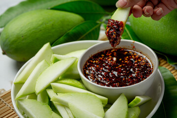 fresh green mango with sweet fish sauce dipping on white background