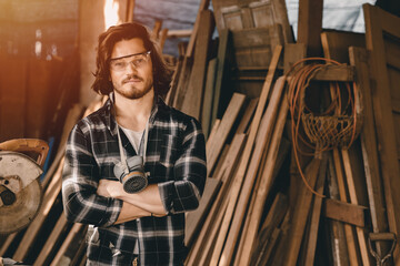 Young carpenters man new generation business wood worker making furniture. Portrait of woodcraft male standing arm crossed at wood workshop.