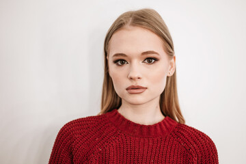 Fototapeta premium beautiful young blonde woman with a beautiful evening makeup stands in a beauty salon on white background