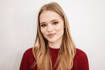 Fototapeta premium beautiful young blonde woman with a beautiful evening makeup stands in a beauty salon on white background