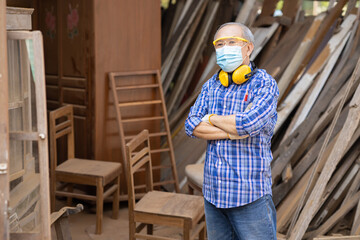 Portrait of elder wood worker hobby for good retirement, Asian male mature professional master of wood craft furniture wooden maker man.