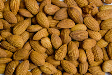 almonds close-up. nuts lie on a plane