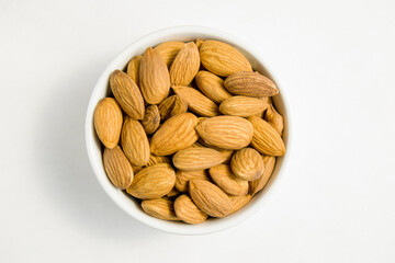 almonds in a white dish on a light background