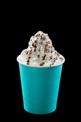 Iced coffee with whipped cream, ice cream and topping in a cardboard glass, black background, isolate