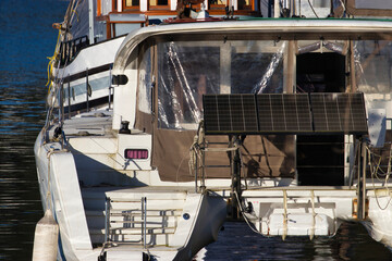 Fototapeta na wymiar solar panels on deck of a small boat creating mobile living