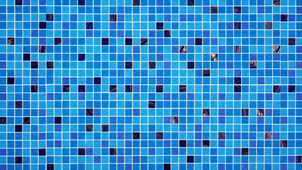 Mosaic blue tiles viewed through the refreshing still water and clear of a swimming pool, Abstract background, Top view