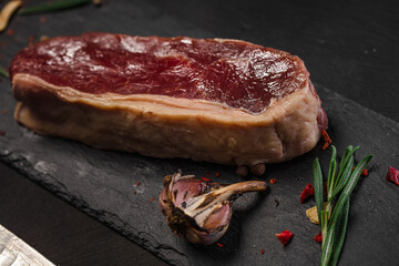 Raw fresh juicy marbled meat on a cutting black board. Black background
Grilled meat with pepper and garliс
Meat for red wine