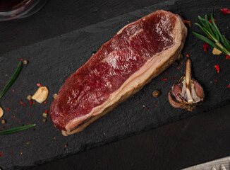 Raw fresh juicy marbled meat on a cutting black board. Black background
Grilled meat with pepper and garliс
Meat for red wine