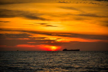 Naklejka na ściany i meble Beautiful sunset over an island, seaside