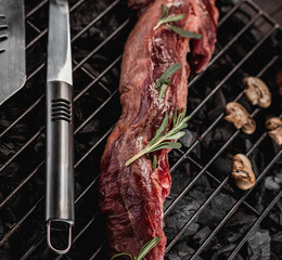 Raw fresh beef whole tenderloin with rosemary and mushrooms on black background
Grill accessories