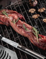 Raw fresh beef whole tenderloin with rosemary and mushrooms on black background
Grill accessories