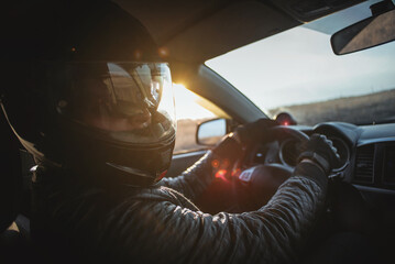 Rally racer in a helmet is driving a car concept.