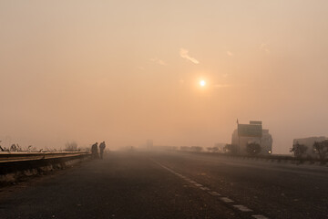 Indian Road Highways, Beautiful landscape of Indian roads during fog and sunrise in winter morning. Vehicles running on highways.
