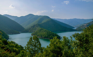 Fototapeta na wymiar The lakes and lush green hills of Rhodope Mountains in Bulgaria