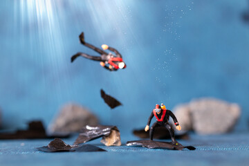 Miniature people , Scuba diver cleans up plastic rubbish pollution discarded in ocean, underwater pollution concept